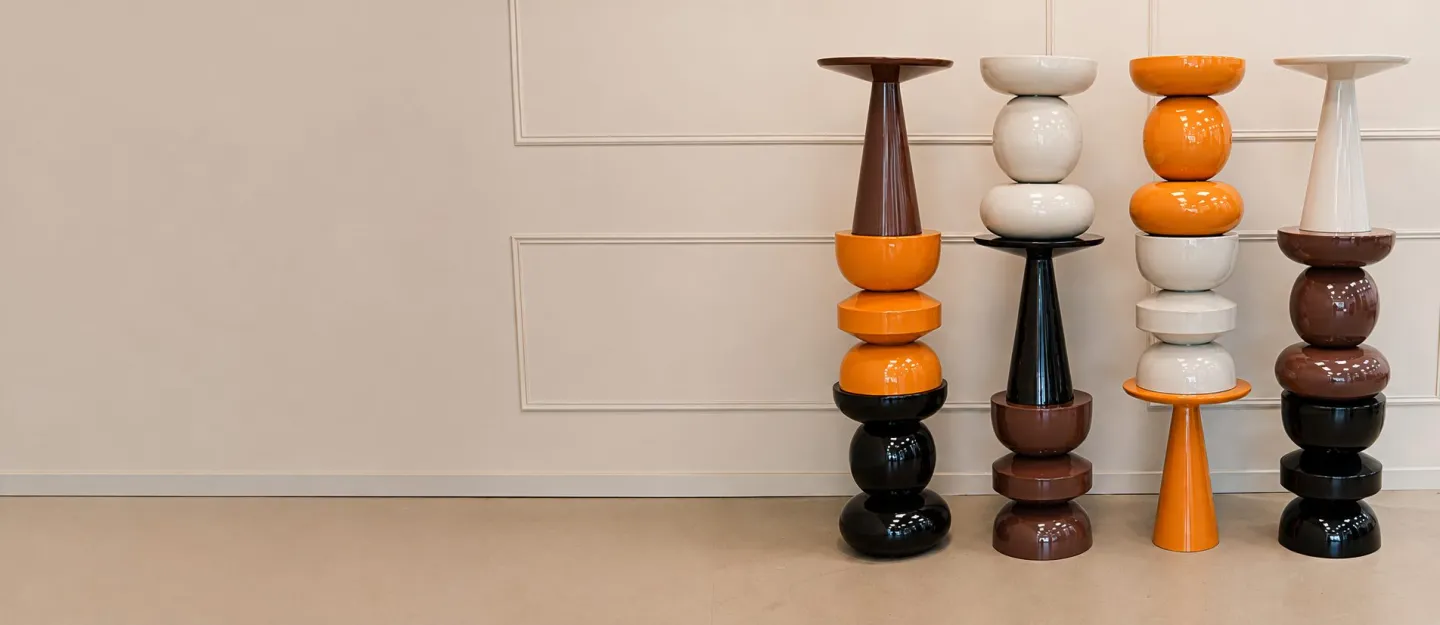 Four organic side tables in orange, brown, black and cream